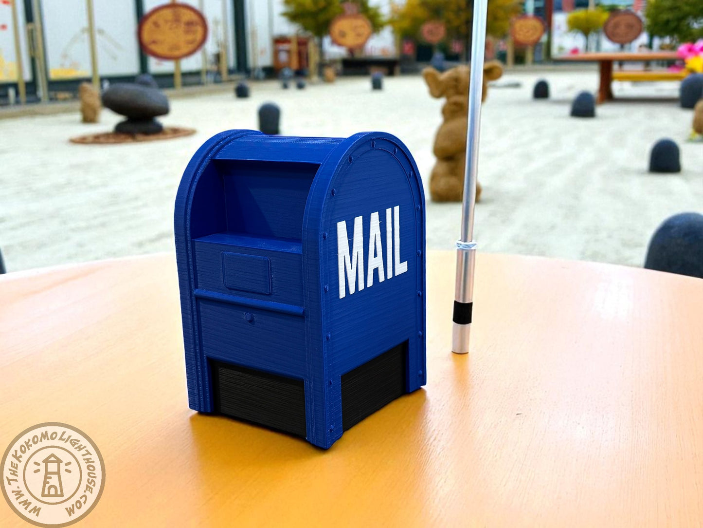 A blue postal piggy bank on a table