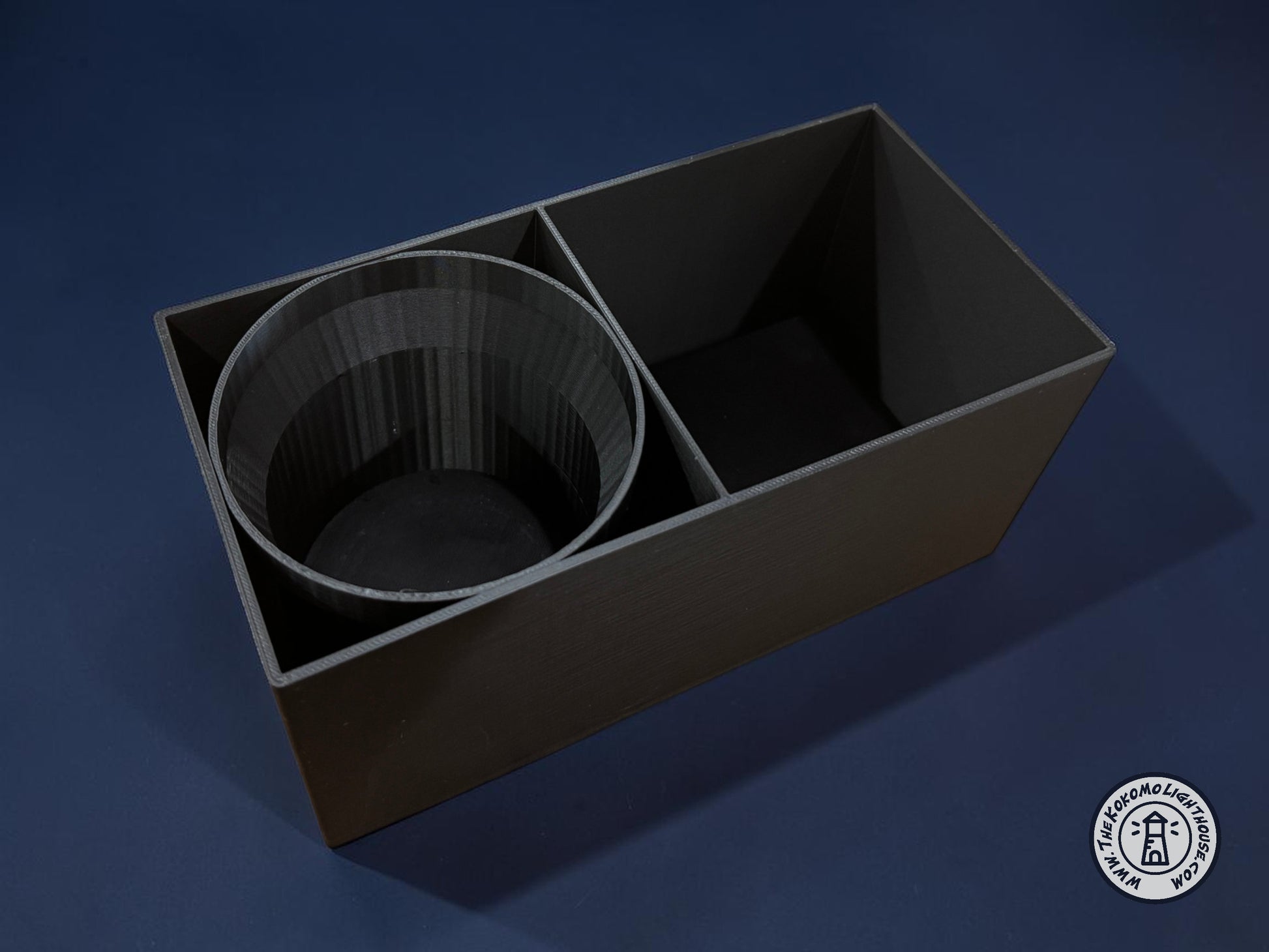 An empty fork truck caddy showing a tumbler insert on a dark blue background.