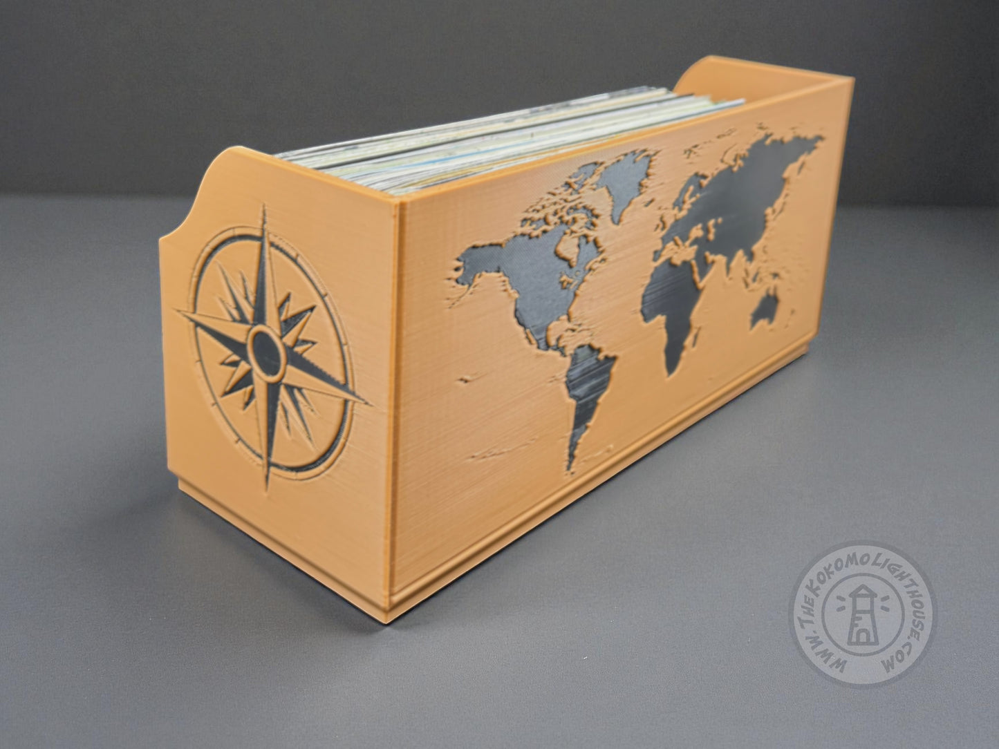 Tan map holder with a black world map and compass design on a gray background