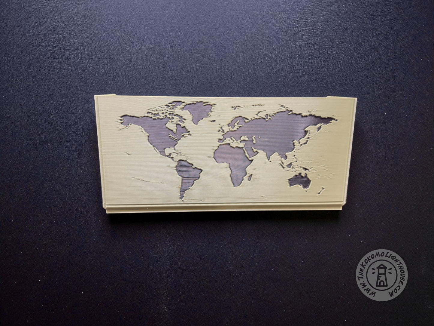 Green map box back showing a black world map