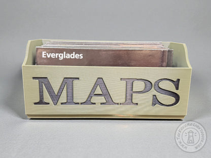 Green Map box with black lettering "MAPS" holding an everglades map unigrid on a gray background