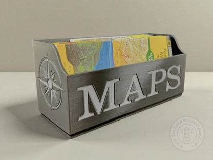 Black Map holder with gray 'MAPS' text containing folded maps on a neutral background