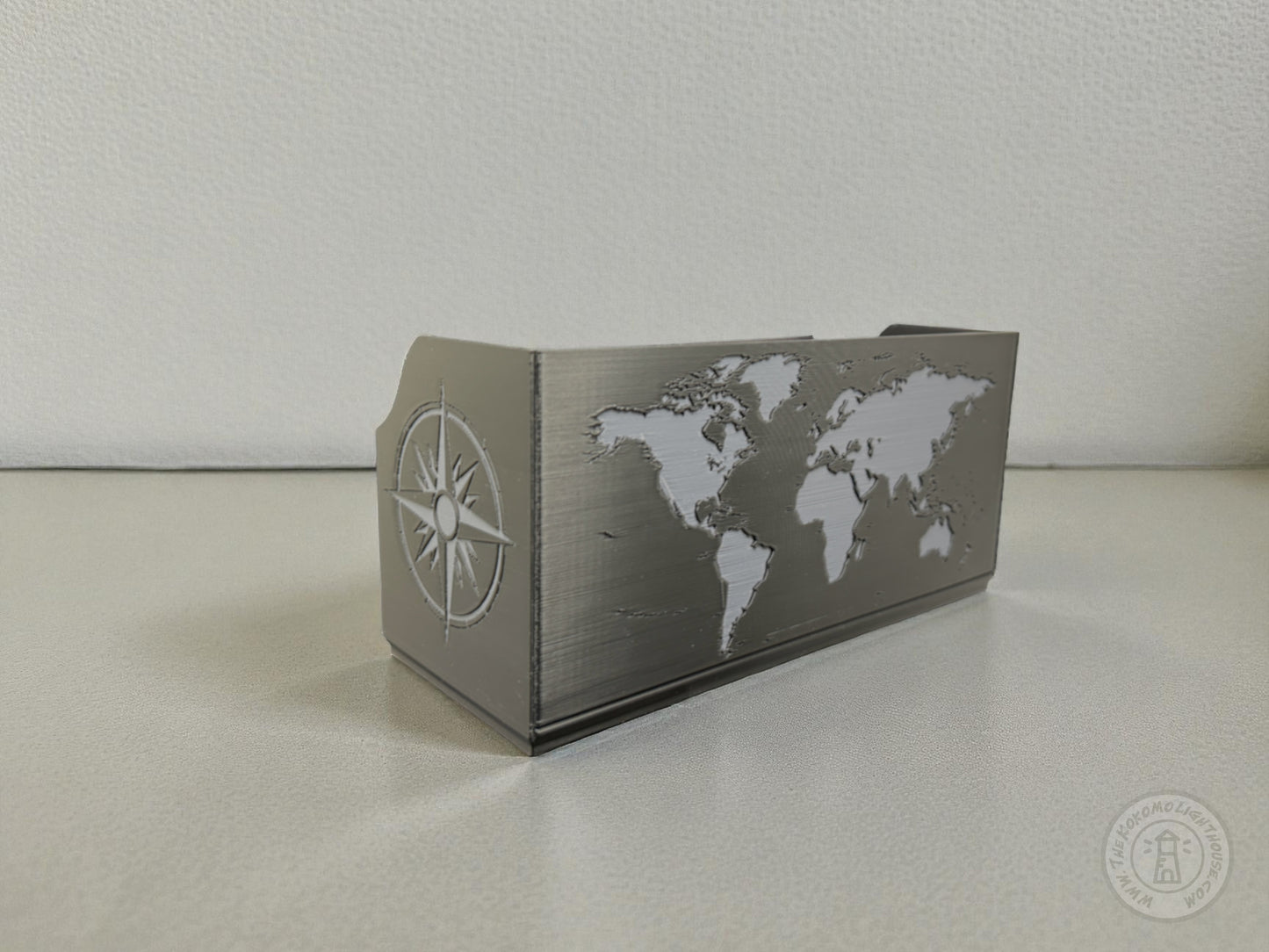 Black Map box with world map design in gray on a light colored surface