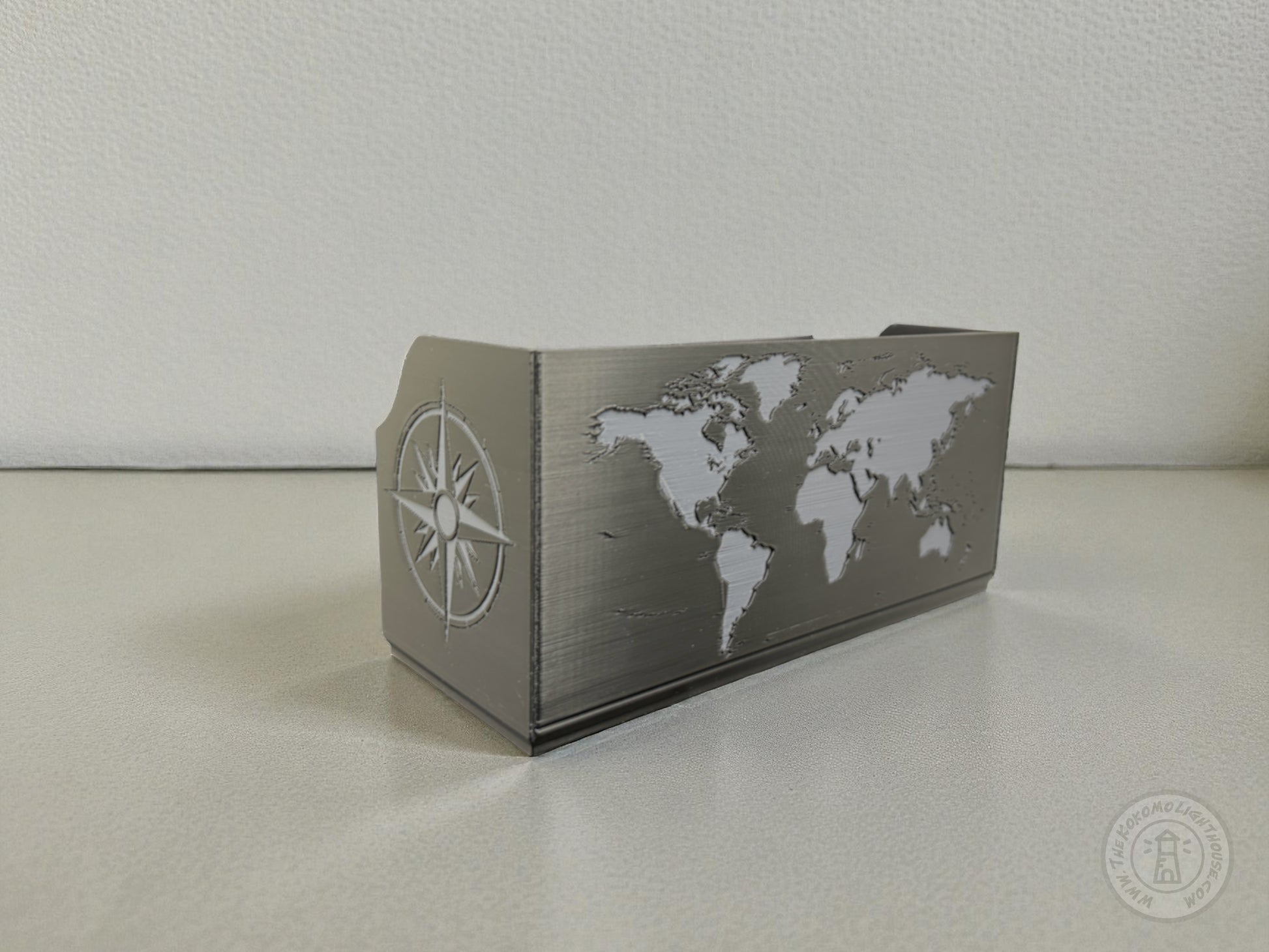 Black Map box with world map design in gray on a light colored surface