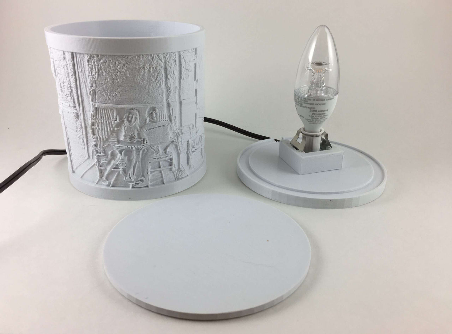 Unlit custom lithophane lamp shown in separate parts, including the white photo shade, lamp base with bulb, and removable top lid.