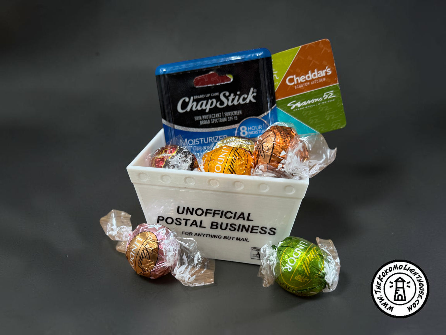 a mini mail tub filled with small candies, a gift card, and a chap stick