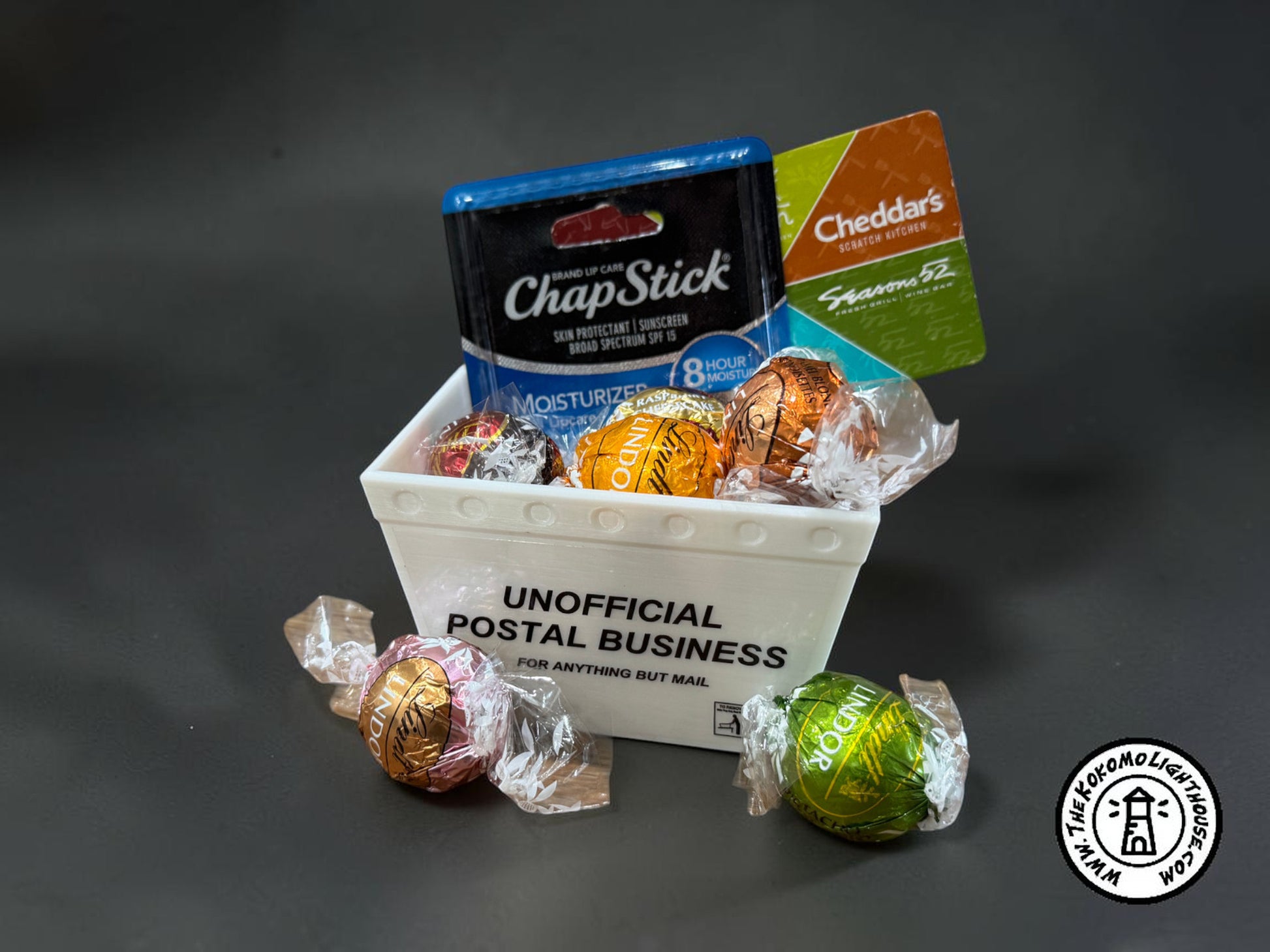 a mini mail tub filled with small candies, a gift card, and a chap stick