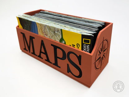 Terrra Cotta Map holder with 'MAPS' in black text and a compass design on a white background