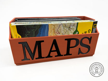Terra Cotta NatGeo Map holder with 'MAPS' text in black letters containing folded national geographic maps on a white background