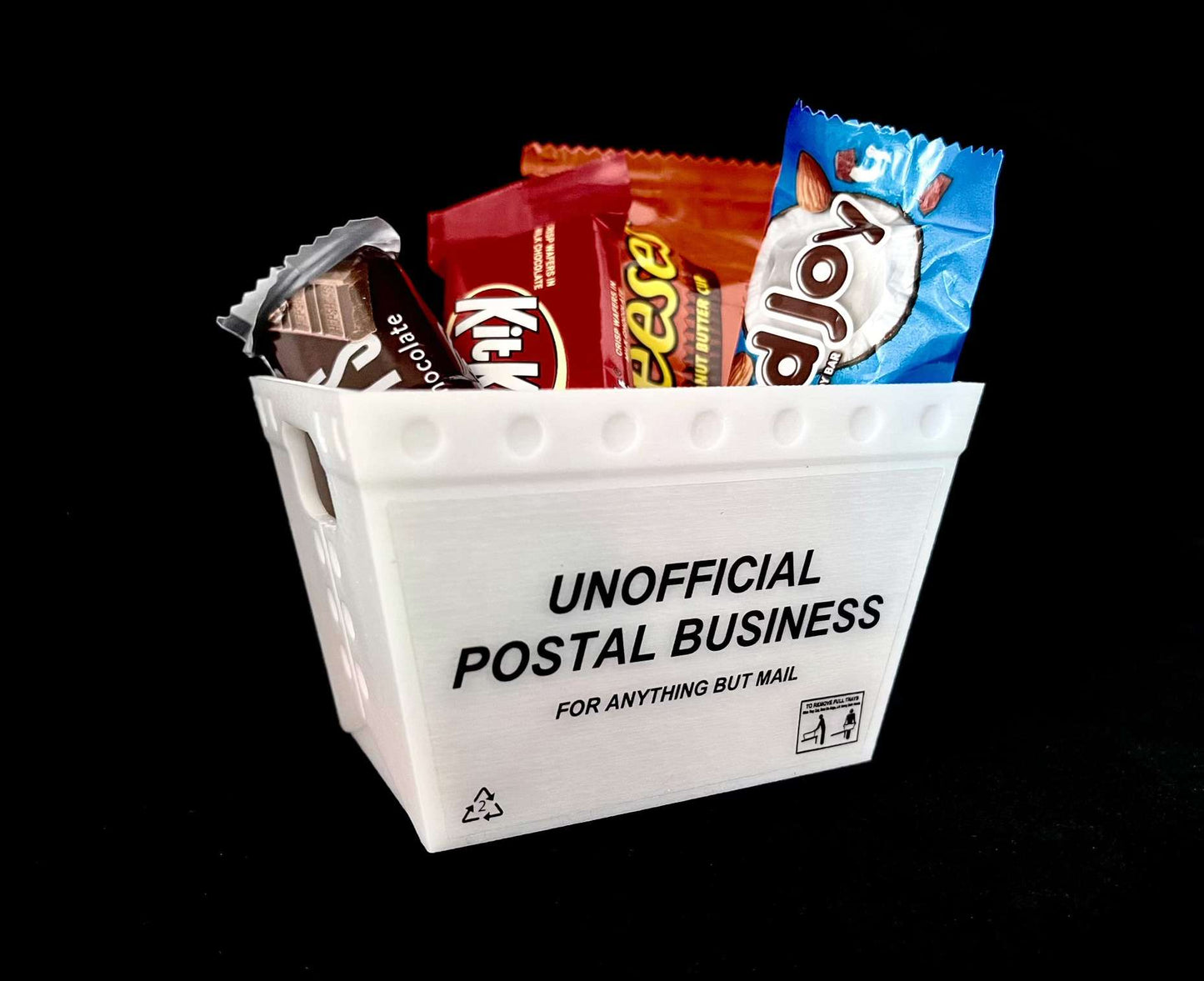 a mini mail tub tote filled with miniature fun size candy bars on  black background