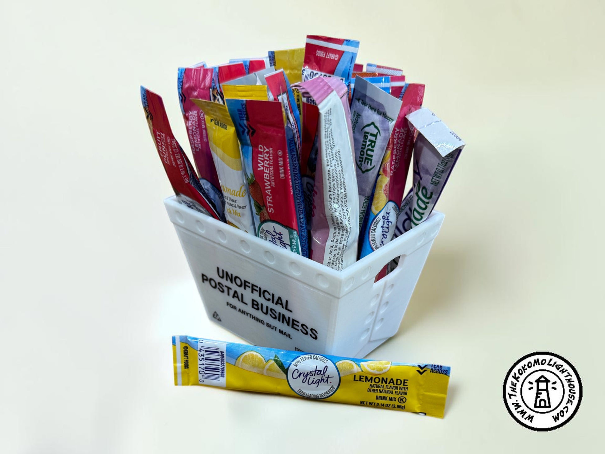 A mini postal tray filled with drink packets with one in front on a light background