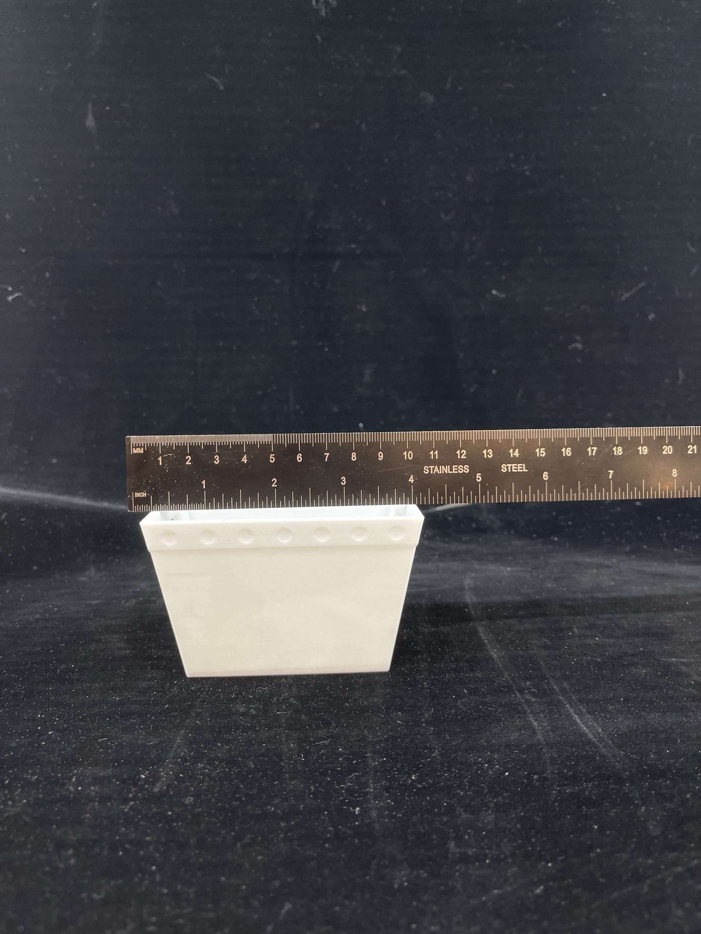 a plain mini postal tub with a ruler showing it is 3.75" wide
