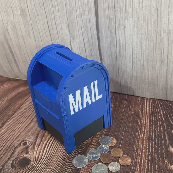 A blue collection box shaped piggy bank having coins inserted and then removed from the bottom