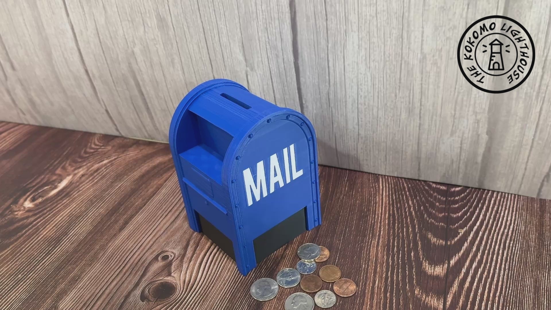 A blue collection box shaped piggy bank having coins inserted and then removed from the bottom